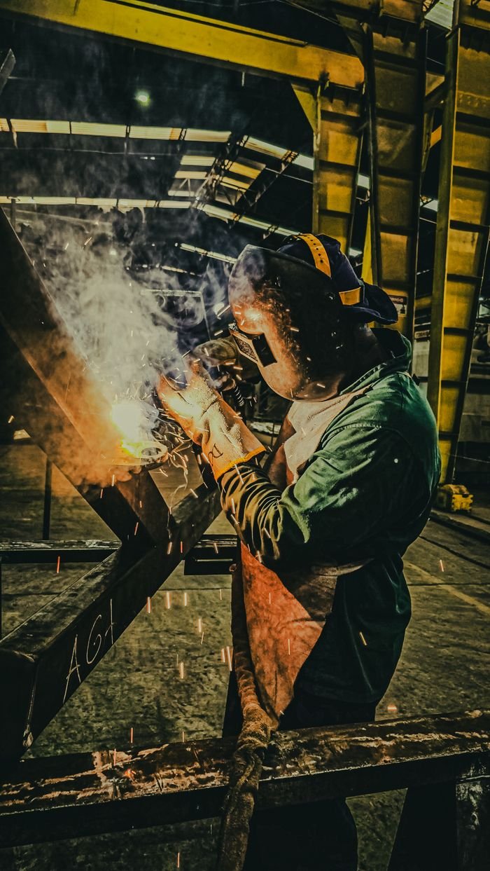 Crafting Captivating Headlines: Your awesome post title goes here A skilled welder works on metal fabrication in a Brazilian factory, showcasing industrial precision.